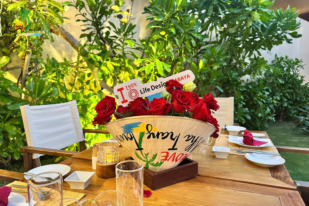 Private dining setup with flowers and tropical greenery, ideal for couples celebrating a special occasion during a luxury holiday