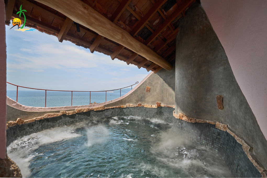 A private soaking pool surrounded by natural stone, offering a relaxing wellness experience