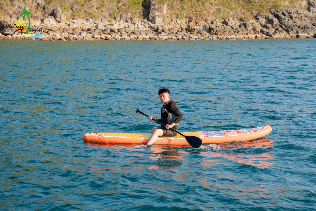 Paddling a kayak across clear coastal waters, offering an active way to explore the bay