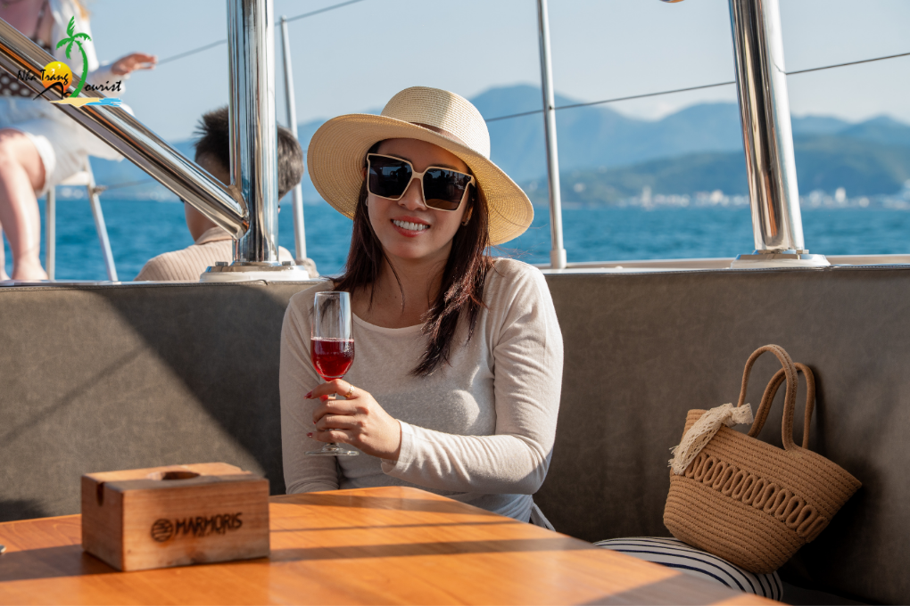 Enjoying a drink aboard a yacht while taking in the sea views during a relaxing cruise