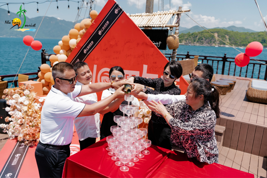 Guests celebrating together aboard a yacht with a champagne tower, creating a memorable setting for a special occasion at sea