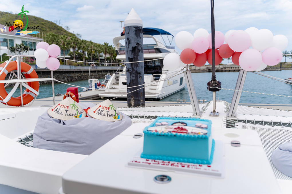 A birthday setup with a cake and balloon decorations onboard a yacht, showing how the space can be arranged for private celebrations and special group occasions